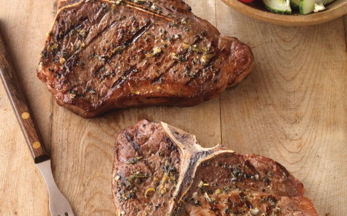 Greek-Seasoned T-Bone Steaks with Cucumber and Tomato Salad